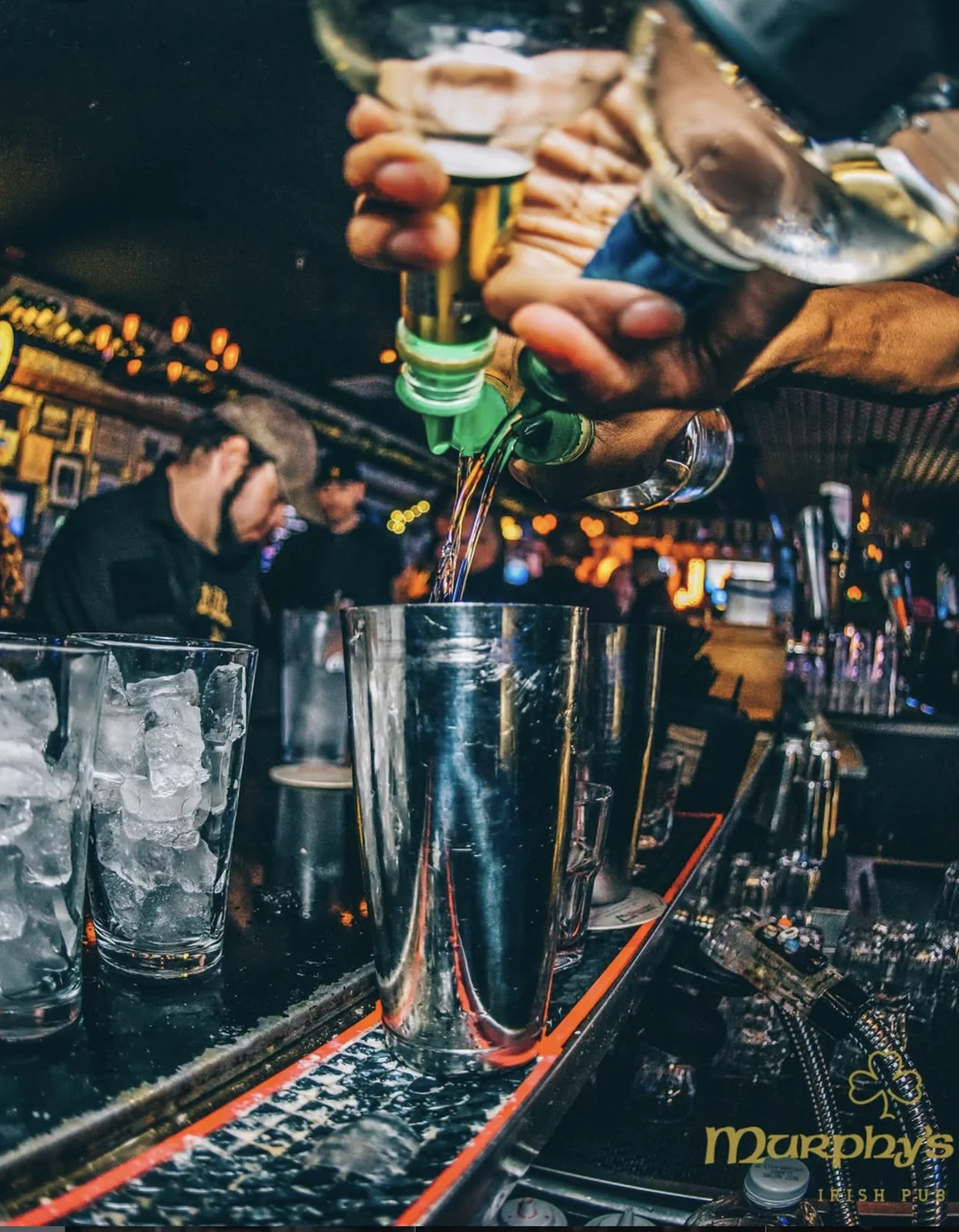 A bartender pouring cocktails at Murphy’s Law Irish Pub